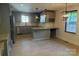 Modern gray kitchen featuring stainless steel appliances, granite counters, and contemporary pendant lights at 3332 Draper Ave, Charlotte, NC 28205