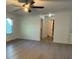 Bright living room featuring a ceiling fan, neutral paint, and access to a closet at 3332 Draper Ave, Charlotte, NC 28205