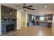 Open living space with a stone fireplace, hardwood floors, and a view of the modern gray kitchen at 3332 Draper Ave, Charlotte, NC 28205