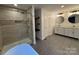 Luxurious main bathroom with a soaking tub, tiled shower, double vanity, and modern fixtures at 3332 Draper Ave, Charlotte, NC 28205