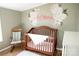 This Bedroom boasts a rocking chair and wooden crib at 3991 Bunker Hill School Rd, Claremont, NC 28610