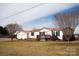 Charming single-story home with a red roof, inviting front porch, and detached garage at 3991 Bunker Hill School Rd, Claremont, NC 28610