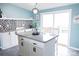 Modern kitchen featuring an island with granite countertops, mosaic backsplash, and white cabinetry at 3991 Bunker Hill School Rd, Claremont, NC 28610