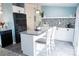 Modern kitchen featuring an island with granite countertops, mosaic backsplash, and black appliances at 3991 Bunker Hill School Rd, Claremont, NC 28610