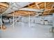 Spacious basement offers exposed wooden beams, laundry area, and potential for customization at 401 N Inman Ave, Bessemer City, NC 28016