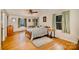 Bright bedroom features hardwood floors, a ceiling fan, and multiple windows offering natural light at 401 N Inman Ave, Bessemer City, NC 28016