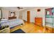 Bedroom with hardwood floors, ceiling fan, and access to a bathroom and closet at 401 N Inman Ave, Bessemer City, NC 28016