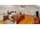 Traditional bedroom with hardwood floors, matching furniture and ceiling fan at 401 N Inman Ave, Bessemer City, NC 28016