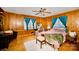 Wood-paneled bedroom with ample light from windows and hardwood flooring at 401 N Inman Ave, Bessemer City, NC 28016