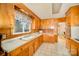 Classic kitchen with wooden cabinetry and ample countertop space under window at 401 N Inman Ave, Bessemer City, NC 28016