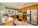 Well-lit kitchen with tile floors, wooden cabinets, and modern appliances at 401 N Inman Ave, Bessemer City, NC 28016