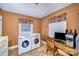 Efficient laundry area with modern washer, dryer and vintage desk at 401 N Inman Ave, Bessemer City, NC 28016