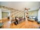 Cozy living room featuring hardwood floors, ceiling fan, and unique wallpaper at 401 N Inman Ave, Bessemer City, NC 28016