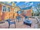 Brick patio area with seating and a fire pit, surrounded by a brick house exterior and greenery at 401 N Inman Ave, Bessemer City, NC 28016