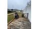 Exterior view of back deck with wood railings and a decorative chiminea at 412 Sumter St # A, Clover, SC 29710