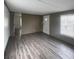 Bright living room featuring wood-look flooring, a window with blinds, and a neutral color palette at 412 Sumter St # A, Clover, SC 29710