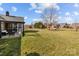 Large backyard features a patio and screened porch with a spacious lawn at 4405 Zee Ct, Monroe, NC 28110