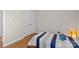 Bright bedroom with hardwood floors, features a striped bedspread and double door closet at 4405 Zee Ct, Monroe, NC 28110