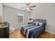 Cozy bedroom features hardwood floors and a soft, gray upholstered bed at 4405 Zee Ct, Monroe, NC 28110