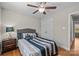 Well-lit bedroom with hardwood floors features closet and ceiling fan at 4405 Zee Ct, Monroe, NC 28110