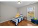 Bedroom with hardwood floors, closet, and window with neighborhood view at 4405 Zee Ct, Monroe, NC 28110