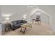 Cozy bonus room with neutral carpet and decor, complemented by natural light from the window at 4405 Zee Ct, Monroe, NC 28110