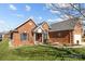 Charming brick home featuring a manicured lawn, mature trees, and a two-car garage at 4405 Zee Ct, Monroe, NC 28110