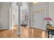 Elegant foyer with hardwood floors, a white front door, and an archway leading to the dining room at 4405 Zee Ct, Monroe, NC 28110