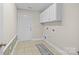 Functional laundry room with white cabinets and convenient washer/dryer hookups at 4405 Zee Ct, Monroe, NC 28110