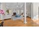 Spacious living room with fireplace, white sofas, a blue ottoman, and hardwood floors at 4405 Zee Ct, Monroe, NC 28110