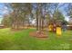 Lush backyard featuring mature trees and a playground for outdoor fun at 4739 Binfords Ridge Rd, Charlotte, NC 28226