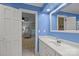 Ensuite bathroom with modern vanity and sink, light blue walls, and access to a bedroom at 4739 Binfords Ridge Rd, Charlotte, NC 28226