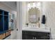 Half bath featuring a modern vanity, decorative mirror, and patterned wallpaper at 4739 Binfords Ridge Rd, Charlotte, NC 28226