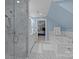 Modern bathroom features a frameless glass shower, soaking tub, and blue accent walls at 4739 Binfords Ridge Rd, Charlotte, NC 28226