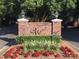 Entrance sign with brick pillars, manicured landscaping, and decorative lighting creating a welcoming atmosphere at 4739 Binfords Ridge Rd, Charlotte, NC 28226