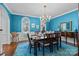 Elegant dining room with blue walls, crown molding, and a chandelier above dining table at 4739 Binfords Ridge Rd, Charlotte, NC 28226