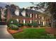 Brick two-story home with manicured lawn, dormer windows, and mature landscaping at 4739 Binfords Ridge Rd, Charlotte, NC 28226