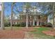 Charming brick home with mature trees, manicured lawn, and classic architectural details at 4739 Binfords Ridge Rd, Charlotte, NC 28226