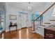Inviting foyer with hardwood floors, staircase, and stained glass window above the door at 4739 Binfords Ridge Rd, Charlotte, NC 28226