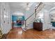 Bright foyer with hardwood floors, staircase, and view into the dining room at 4739 Binfords Ridge Rd, Charlotte, NC 28226