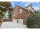 Attached brick two-car garage with carriage doors and ample parking on the concrete driveway at 4739 Binfords Ridge Rd, Charlotte, NC 28226