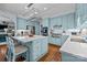 Spacious kitchen with light-blue cabinetry, an island with seating, stainless appliances, and hardwood floors at 4739 Binfords Ridge Rd, Charlotte, NC 28226