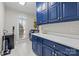Laundry room featuring blue cabinets, a white countertop, and stainless steel washer and dryer at 4739 Binfords Ridge Rd, Charlotte, NC 28226