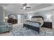 Comfortable main bedroom features a trey ceiling, soft blue walls, and beautiful furniture at 4739 Binfords Ridge Rd, Charlotte, NC 28226