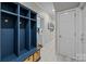 Mud room with custom blue storage lockers, wicker baskets, and neutral-colored walls at 4739 Binfords Ridge Rd, Charlotte, NC 28226