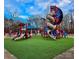 Community playground with colorful slides and climbing structures, surrounded by lush green space and trees at 4739 Binfords Ridge Rd, Charlotte, NC 28226