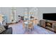 Sunny playroom with large windows, light hardwood floors, and patterned rug, ready for fun at 4739 Binfords Ridge Rd, Charlotte, NC 28226