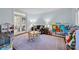 Bright playroom features a patterned rug, a table with chairs, and shelving filled with toys at 4739 Binfords Ridge Rd, Charlotte, NC 28226