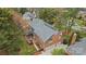 Aerial view of a brick house with a grey roof, patio, and mature trees in a desirable neighborhood at 4739 Binfords Ridge Rd, Charlotte, NC 28226