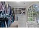 Large walk-in closet offers ample storage space with custom shelves, drawers, and a big window at 4739 Binfords Ridge Rd, Charlotte, NC 28226